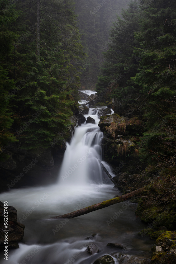 Fototapeta premium Sucu waterfall flowing through rocks in a deep forest