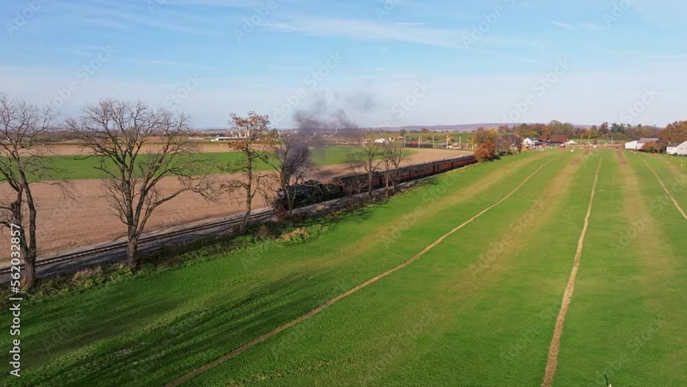 Aerial View of a Single Rail Road Track Going Thru Country Farmlands as a Steam Train Approaches Aerial View of a Single Rail Road Track Going Thru Country Farmlands as a Steam Train Approaches