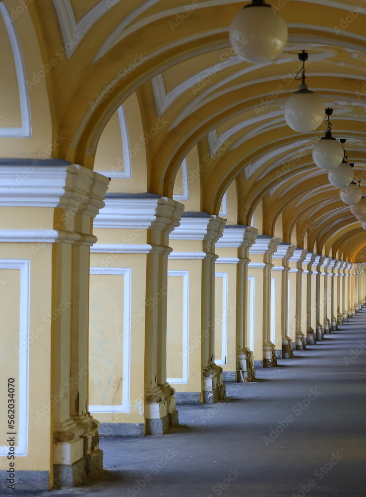 Yellow arched Colonnade of the Old Gostiny Dvor, Dumskaya Street, St. Petersburg, Russia, January 2023