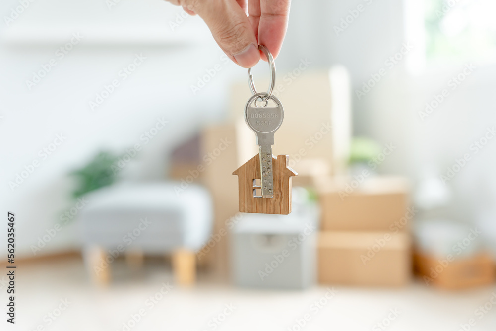 Moving house, relocation. Woman hold key house keychain in new apartment. move in new home. Buy or rent real estate. flat tenancy, leasehold property, new landlord, dwelling, loan, mortgage.. - obrazy, fototapety, plakaty 
