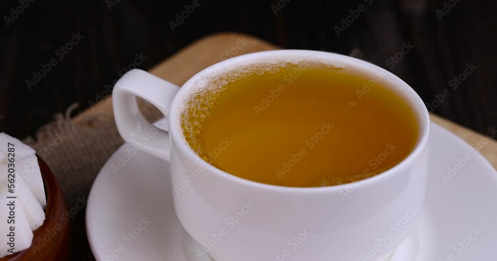 brewing green tea with hot boiled water in a mug brewing green tea with hot boiled water in a mug