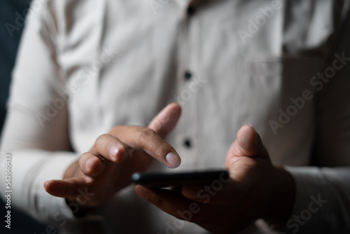 Business man scrolling smartphone for trend Analysis