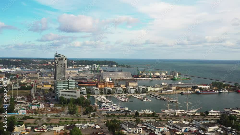 Drone aerial view panning docks, marina, and boats in port city of Gdynia Poland