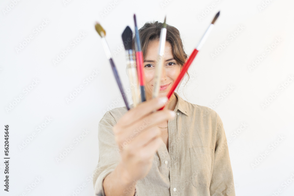 Happy woman with painting Brushes Choice Artist Creativity