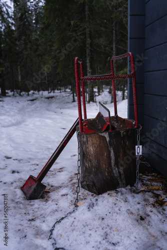 Firewood splitter and hammer on snow in winter. photo
