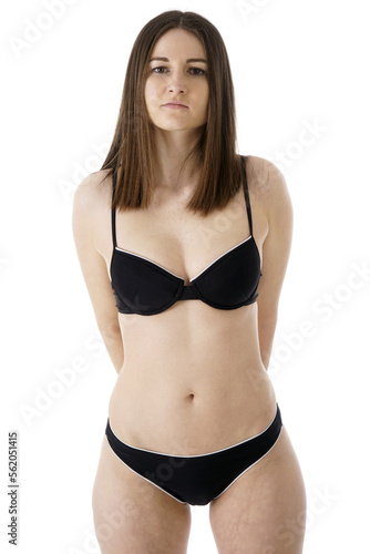 Slim athletic girl posing in black bikini in studio 