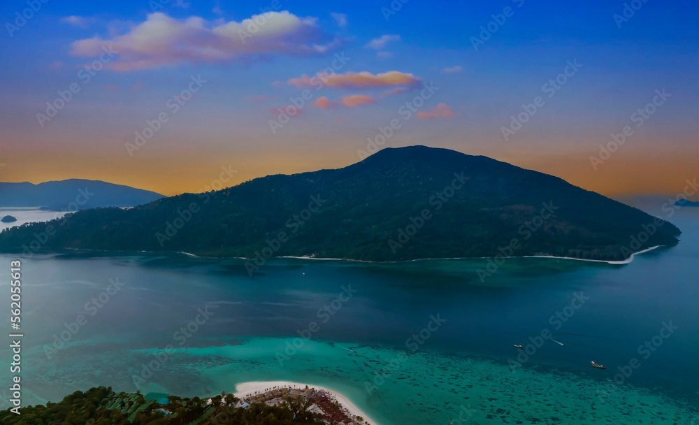 The sunset sky scene as tropical with seashore island in a coral reef ,blue and turquoise sea Amazing nature landscape as blue lagoon