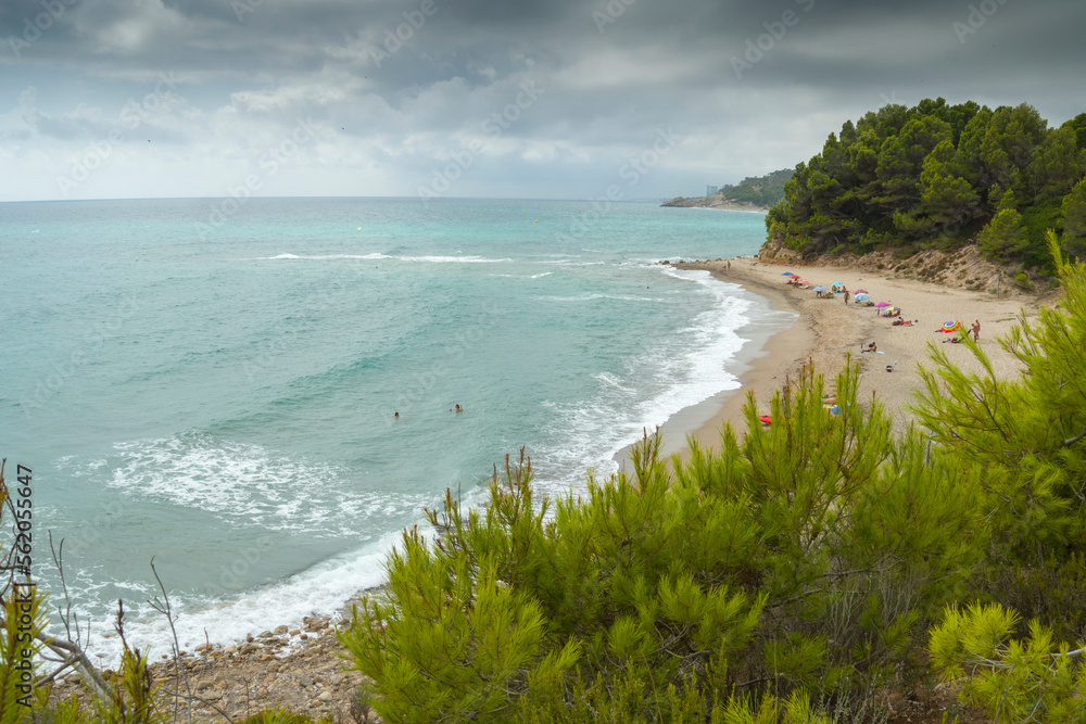 Tarragona Catalonia Spain   summer view of cala Torn nudist beach in a cloudy morning