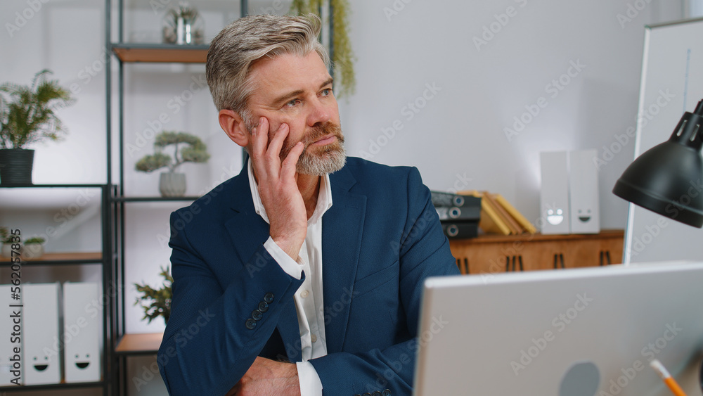 Stressed sad mature businessman losing job having financial problems at office workplace. Frustrated middle aged gray-haired freelancer man thinking of money debt, budget loss bankruptcy. Overworking Stressed sad mature businessman losing job having financial problems at office workplace. Frustrated middle aged gray-haired freelancer man thinking of money debt, budget loss bankruptcy. Overworking
