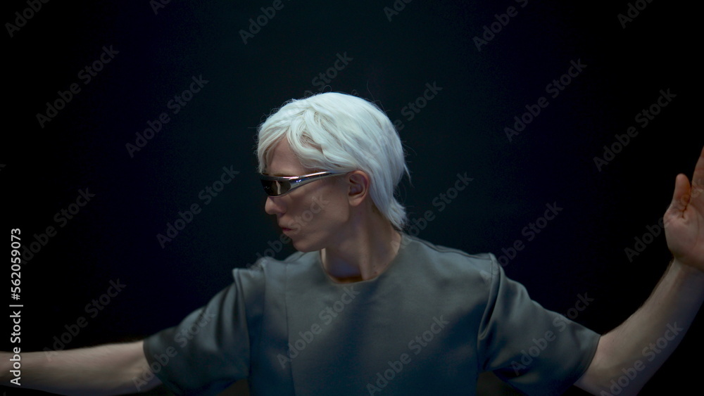 Guy experiencing augmented reality in futuristic glasses dark background closeup