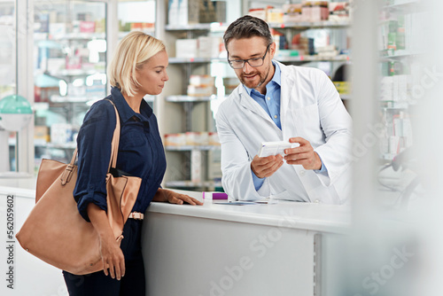 Man, pharmacist and help customer, prescription and explain instructions for medicine, vitamins and wellness. Pharmacy, female client and medical professional speaking, pills and healthcare advice photo