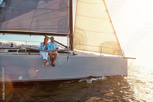 Yacht, sea and love with a mature couple sailing together on water for holiday, vacation or romance. Boat, ocean and date with a senior man and woman bonding while enjoying a trip on the water