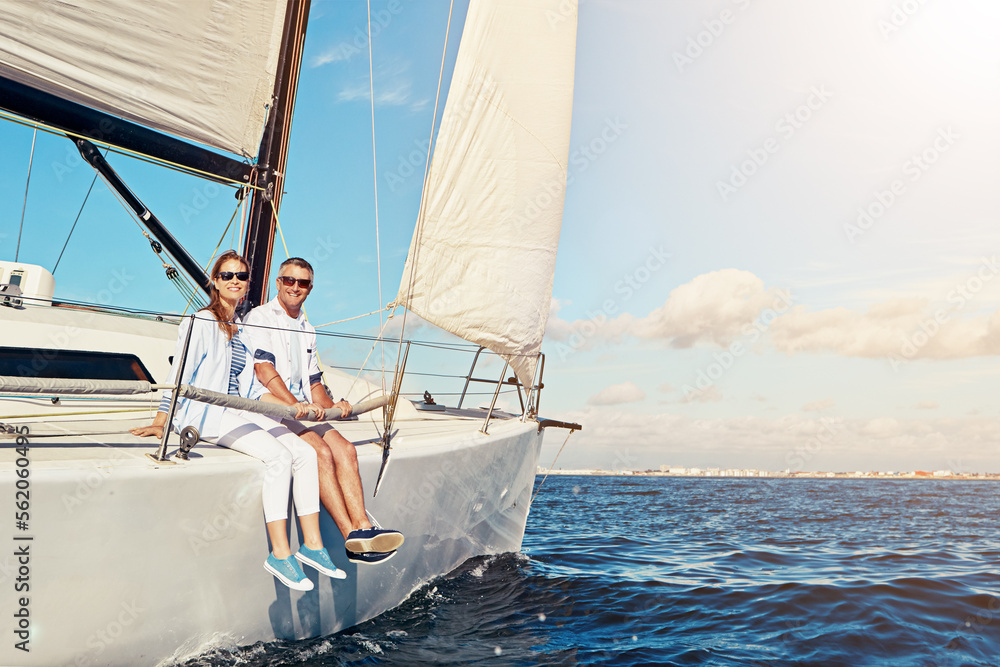 Obraz premium Vacation, ocean and portrait of a couple on a yacht for adventure, freedom and sailing trip. Travel, summer and mature man and woman on a boat in the sea for a romantic seaside holiday in Greece.
