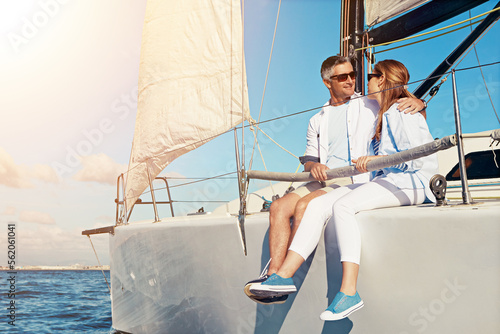 Summer, yacht and love with a couple dating on the ocean for travel, romance or honeymoon celebration. Water, luxury or cruise with a married man and woman sitting together on a boat out at sea © Reese/peopleimages.com