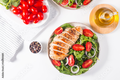 Salad with grilled chicken fillet meat, fresh vegetables, spinach, ruccola, red onion and tomato. Healthy menu. Diet food. Top view. Banner 