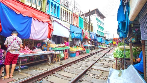 Timelapse of riding train through Maeklong Railway Market, Thailand photo