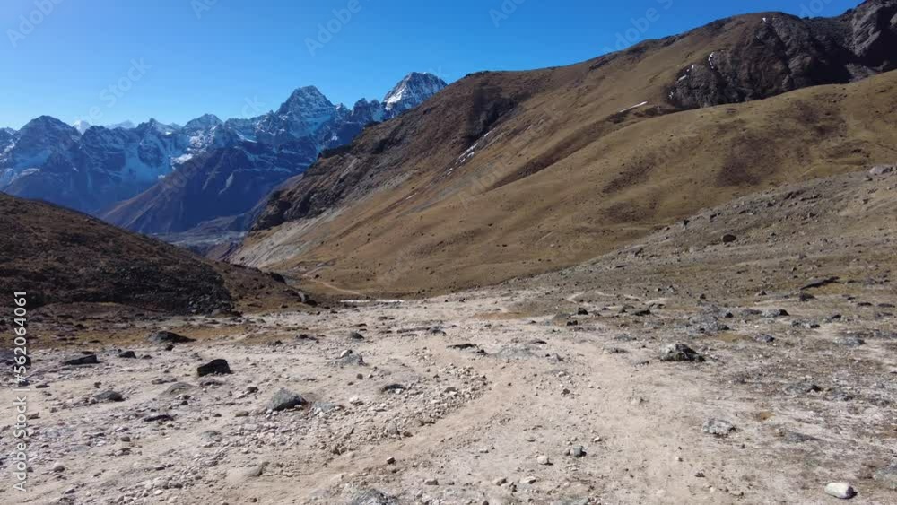 Cho La Pass, Nepal: Point of view of an hiker walking down the Chola pass toward Dragnag, or Thragnak, in the Gokyo valley coming from the Everest base camp in the Himalayas in Nepal. Cho La Pass, Nepal: Point of view of an hiker walking down the Chola pass toward Dragnag, or Thragnak, in the Gokyo valley coming from the Everest base camp in the Himalayas in Nepal.