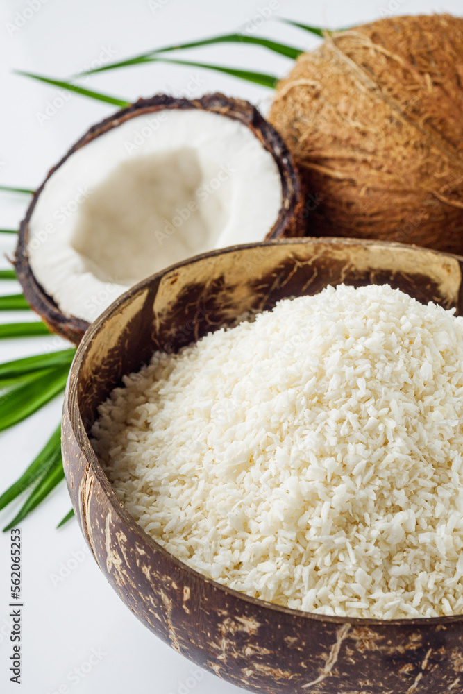fresh natural coconut and shavings dried flakes on white acrylic background fresh natural coconut and shavings dried flakes on white acrylic background