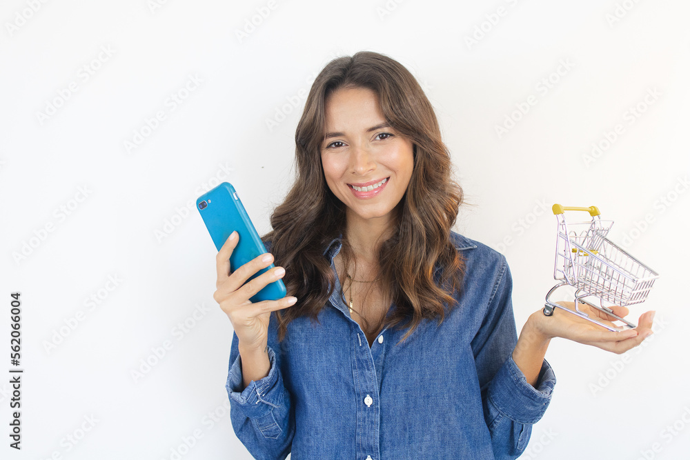 Happy Woman Online Shopping Holding Smartphone and Shopping Cart Happy Woman Online Shopping Holding Smartphone and Shopping Cart