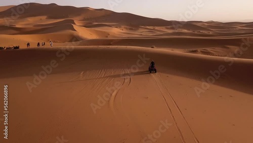 Aerial view a guy driving a quad in Moroccan Sahara desert. Sahara quad experience. photo