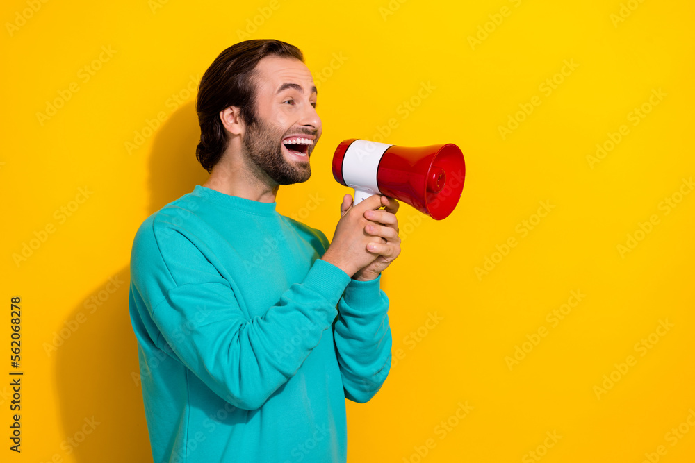 Photo of funny funky man wear turquoise clothes screaming toa empty space isolated yellow color background Photo of funny funky man wear turquoise clothes screaming toa empty space isolated yellow color background