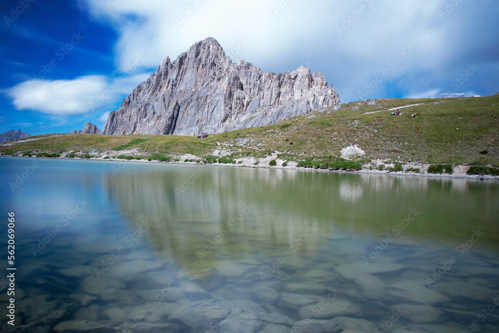 Rocca la Meja, a mountain in the Cottian Alps, Piedmont, northern Italy, is reflected in the clear waters of an alpine lake on a clear summer day.