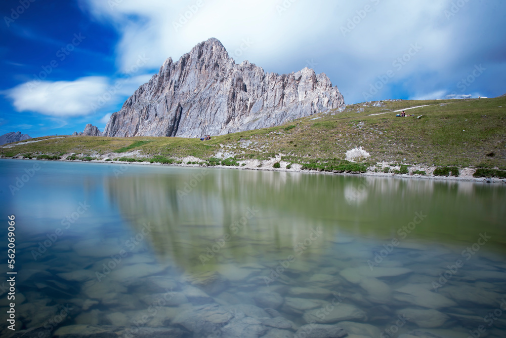 Rocca la Meja, a mountain in the Cottian Alps, Piedmont, northern Italy, is reflected in the clear waters of an alpine lake on a clear summer day.