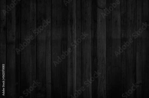 Dark wood plank texture background. Vintage black wooden wall antique cracking old design. Painted weathered peeling table wood hardwood decoration.