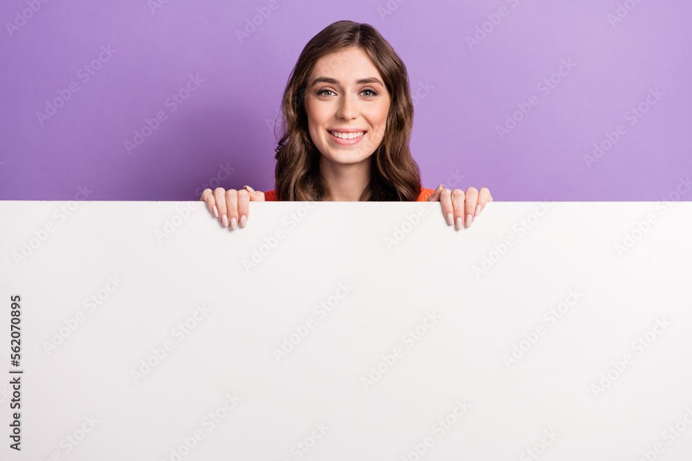 Photo of young promoter lady smiling hold huge paper white wall proposition new brand clothes sale shopping isolated on violet color background Photo of young promoter lady smiling hold huge paper white wall proposition new brand clothes sale shopping isolated on violet color background
