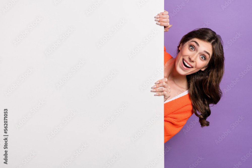 Photo of funny overjoyed excited woman hide behind big white billboard crazy low price proposition new gadgets isolated on violet color background Photo of funny overjoyed excited woman hide behind big white billboard crazy low price proposition new gadgets isolated on violet color background