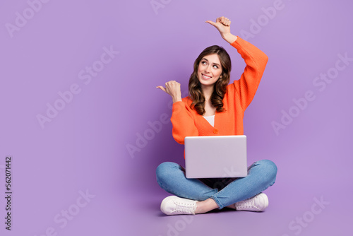 Full length photo of charming cute woman dressed cardigan typing gadget thumbs empty space isolated purple color background