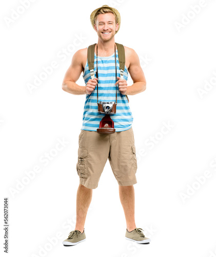 A handsome young tourist standing alone in the studio while carrying his camera and backpack isolated on a PNG background.