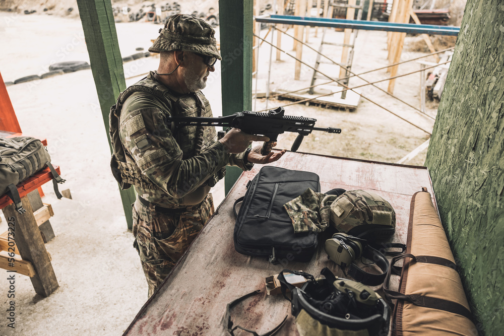 Fototapeta premium New soldier in a military camp learning to use rifle