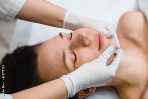Female chin and neckline massage in salon
