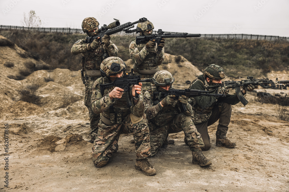 Group of soldiers in camouflage with rifles in hands Group of soldiers in camouflage with rifles in hands