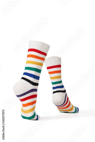 Detailed shot of bright colorful rainbow striped socks with a wide rubber band. The socks are shaped as walking human legs. The unisex striped socks are isolated on a white background.