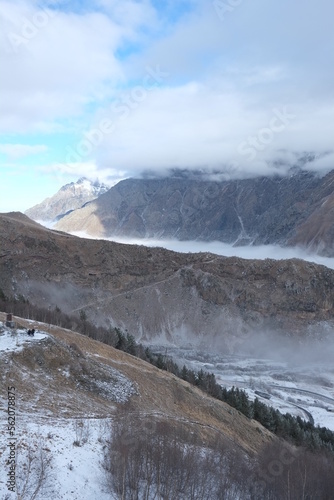 Georgian mountains. Kazbegi. Snow hills, epic clouds