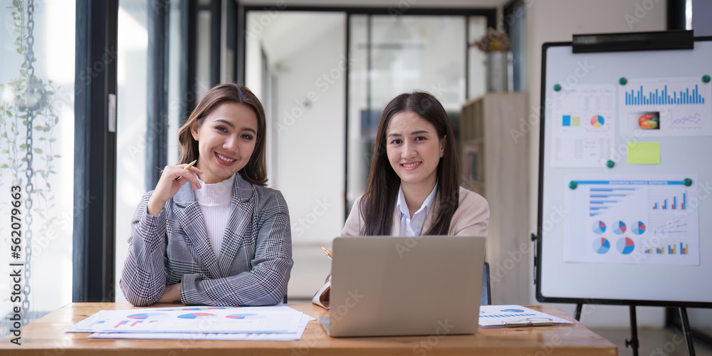 Teamwork of business people analysis graph at meeting room. Asian business advisor meeting to analyze and discuss on the financial report Teamwork of business people analysis graph at meeting room. Asian business advisor meeting to analyze and discuss on the financial report