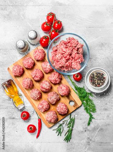Raw beef meatballs with spices and fragrant dill .