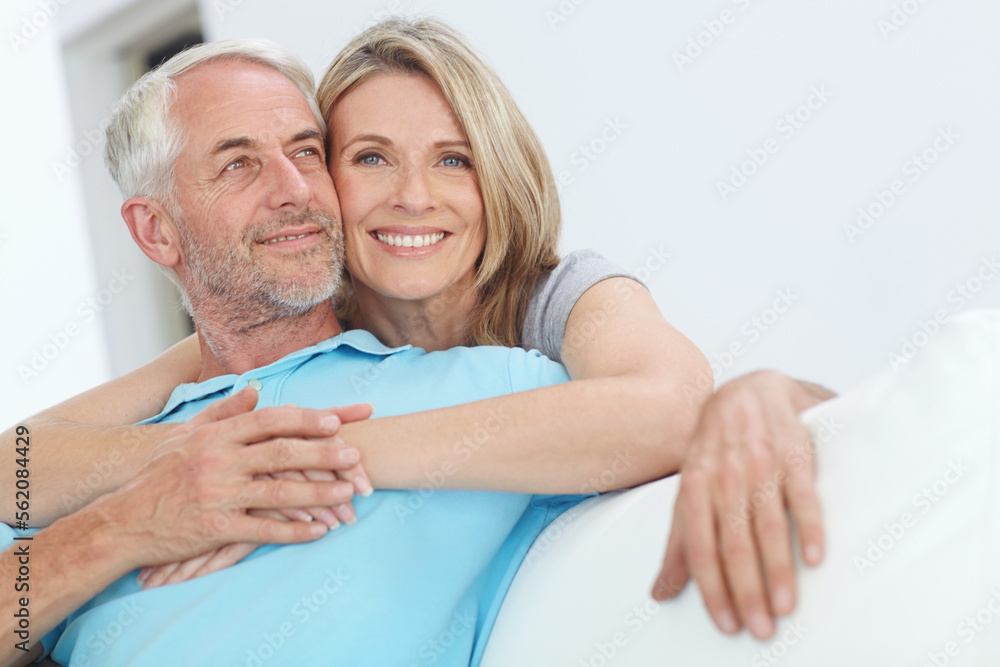 Fototapeta premium Senior couple, hug and happy portrait with love at home for trust, care and support for retirement. Commitment of man and woman in a healthy marriage and lifestyle with security on living room couch