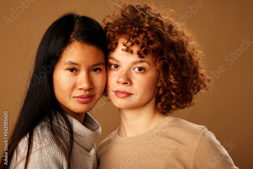 Diversity. A multiracial girls hugging and posing in studio.