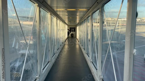 Passenger POV boarding plane inside airplane bridge. Person entering aircraft photo