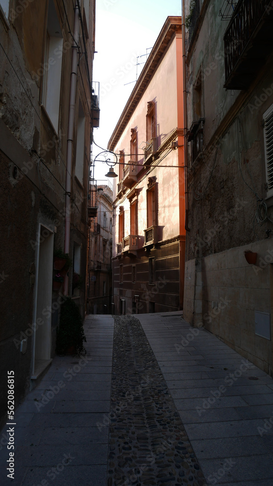 A typical winding and narrow street in Cagliari, Sardinia.  Brightly painted houses.