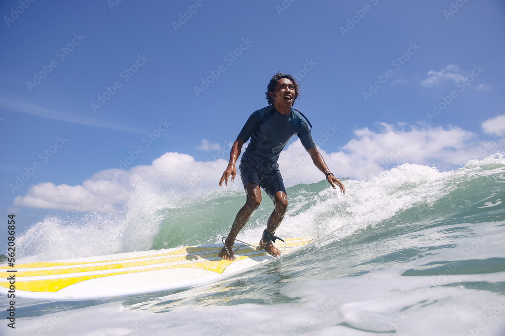 Portrait of carefree smiling man surfing in sea Portrait of carefree smiling man surfing in sea
