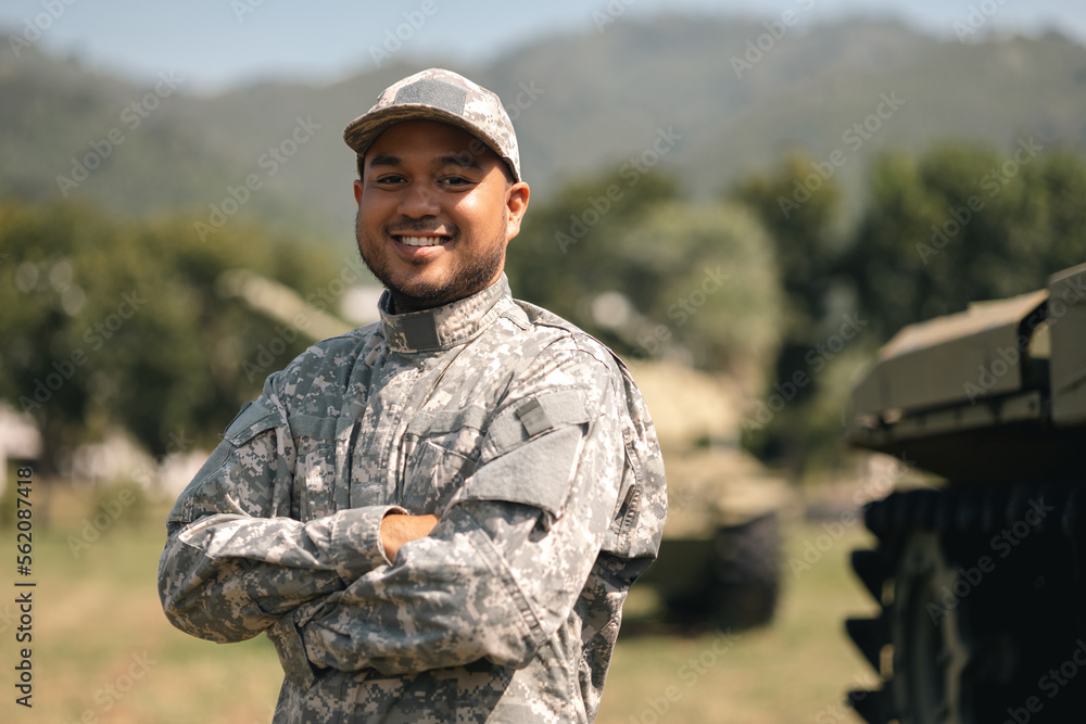 Asian man special forces soldier standing against on the field Mission. Commander Army soldier military defender of the nation in uniform standing near battle tank while state of war.