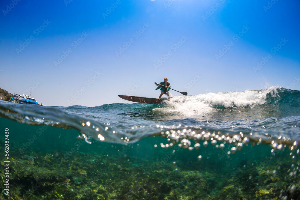 Sup surfing in tropical water. Sup surfing in tropical water.