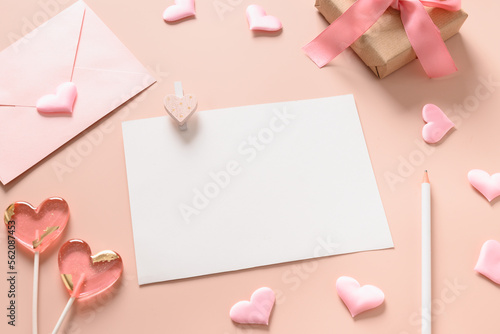 Valentine's blank card for love letter and pink envelope, gift, lollipops as heart on pink background. Copy space. Close up. © svetlana_cherruty