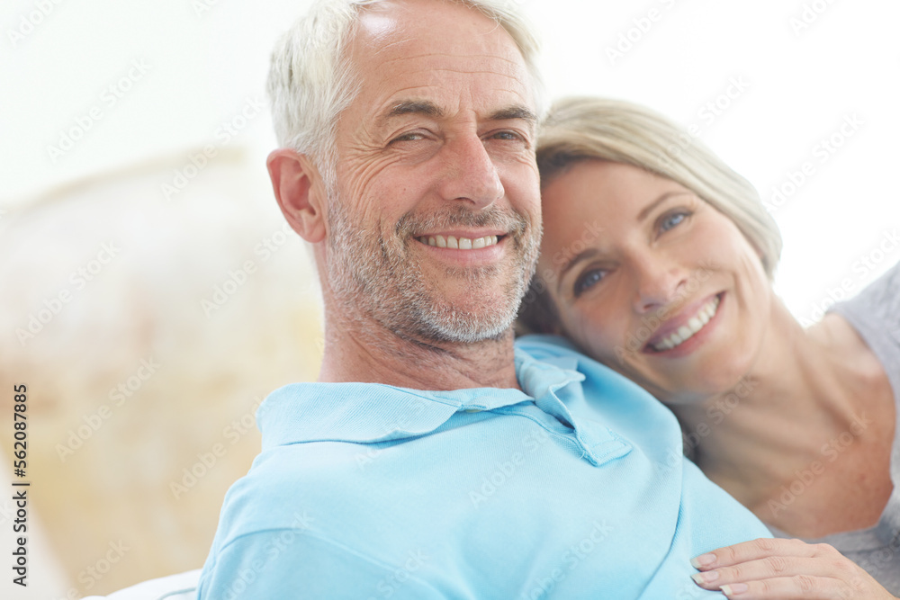 Senior couple, retirement and portrait in their home with love, care and support from life insurance. Commitment of a man and woman in a healthy and happy marriage with security on living room couch
