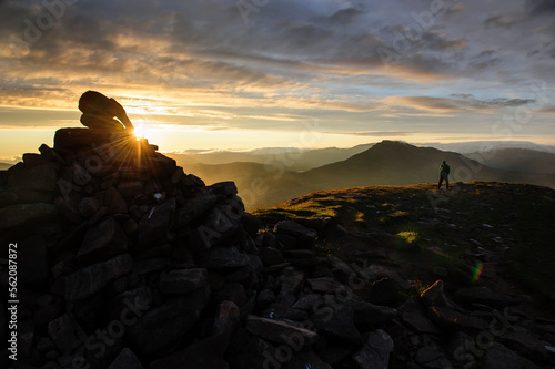 A hiker walks the summit of The Suilven mountain during sunrise. Scotland, United Kingdom. photo