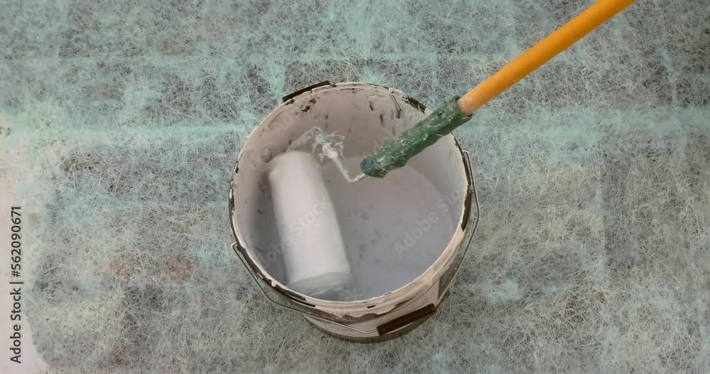 Workers who carry out the waterproofing of a terrace with resin, making the surface pedestrian and with excellent aesthetics Workers who carry out the waterproofing of a terrace with resin, making the surface pedestrian and with excellent aesthetics